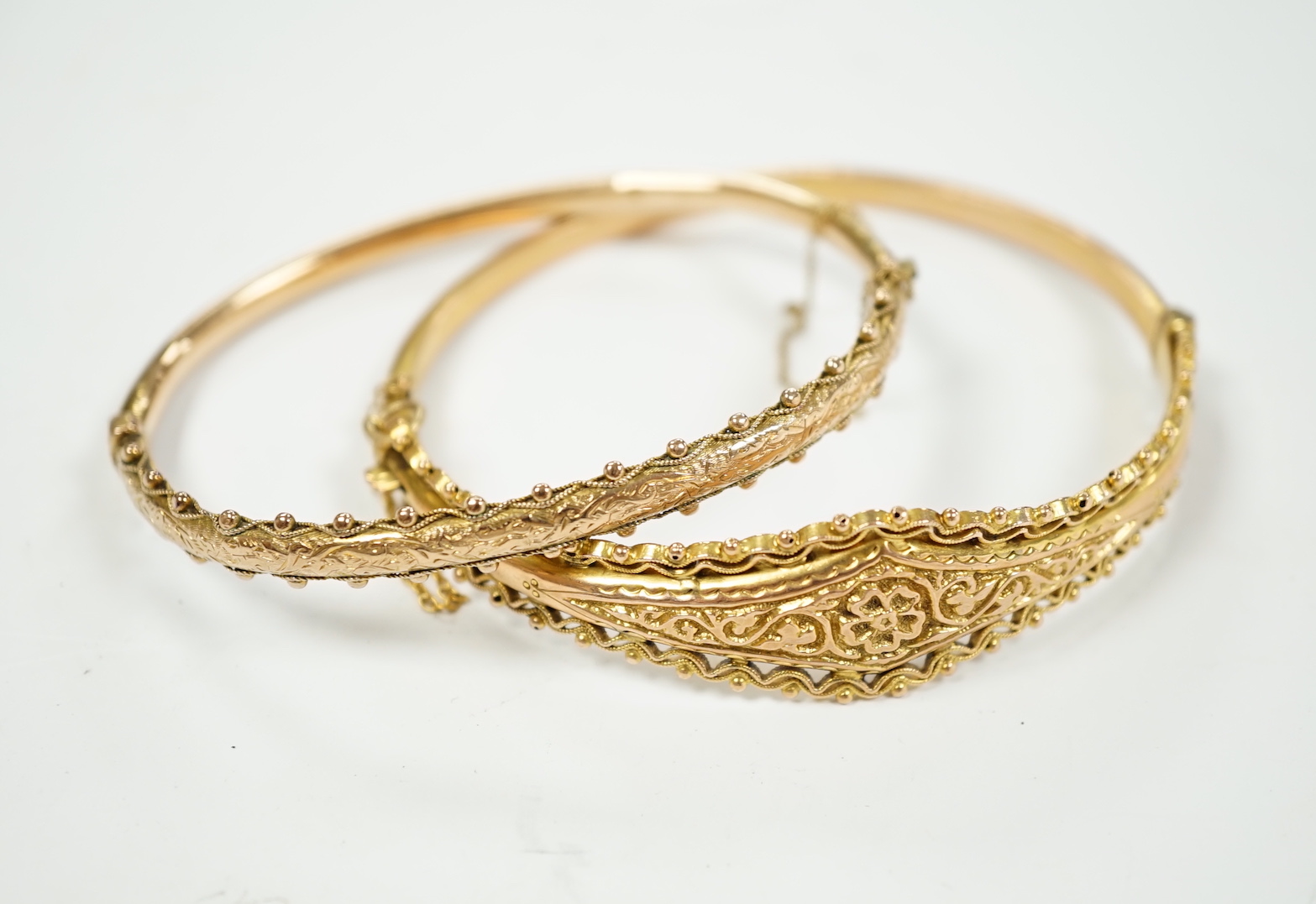 Two yellow metal hinged bracelets, one stamped 9ct gold, hallmarked bracelet 9.2 grams.